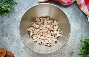 Virtą vištienos filė supjaustykite mažais kubeliais ir sudėkite į dubenį.