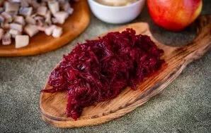 Nulupkite virtus burokėlius ir stambiai sutarkuokite. Jei įmanoma, rankomis nuspauskite sultis. Tai būtina, kad salotos nepermirktų.