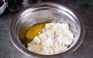 Paruoškite varškės įdarą. Sudėkite varškę į dubenį, įmuškite kiaušinį ir įberkite 40 gramų cukraus.